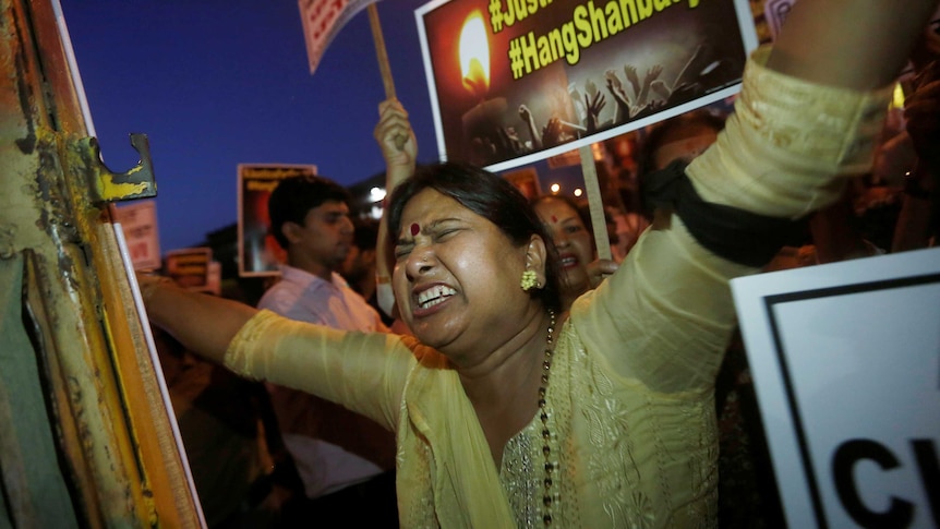 A woman shouts slogans.