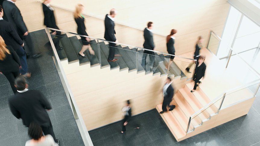 A stream of people exiting the office