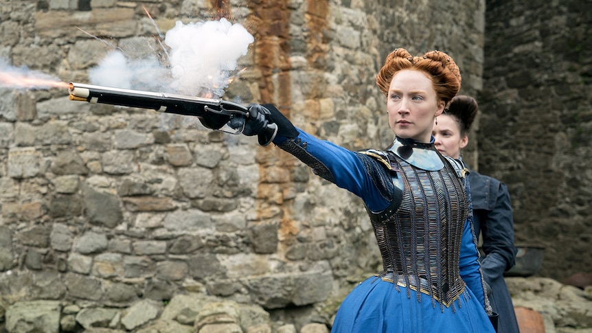 Colour still of Saoirse Ronan shooting a firearm as Mary Stuart in 2018 film Mary Queen of Scots.