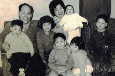 The Foong family sitting on the couch.