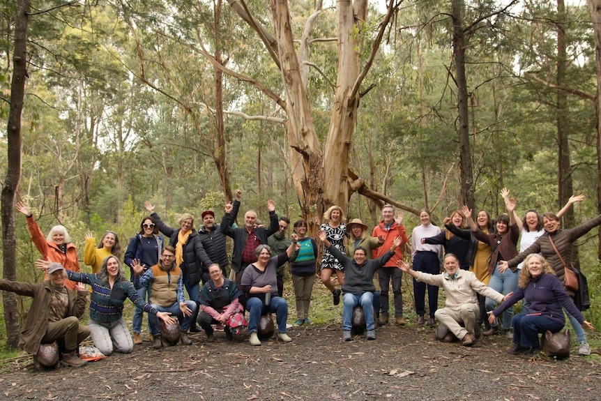 Group of people pose for photo in bushland