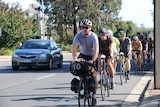 Jimmy Ashby on the road with a group of cyclists as he begins his ride around the world.