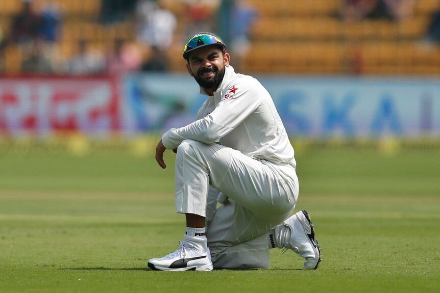 India's Virat Kohli reacts to a missed catch against Australia in Bangalore