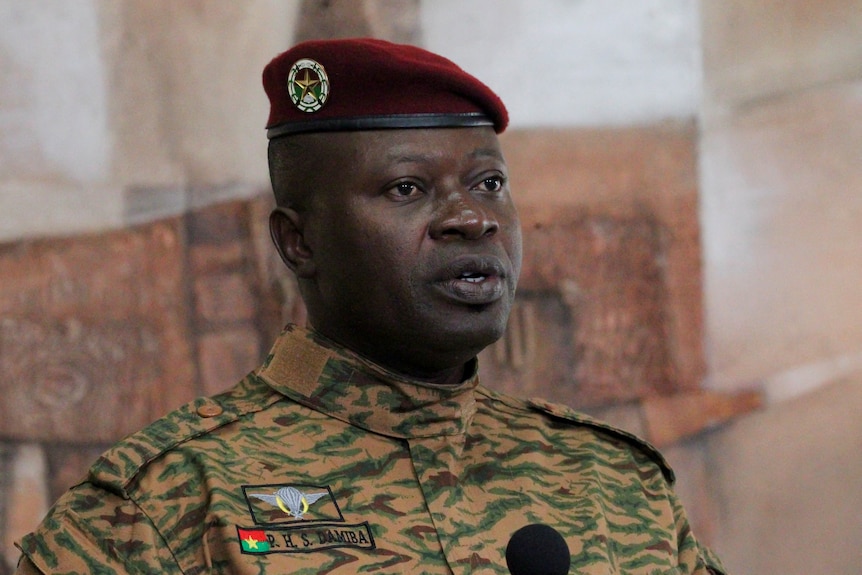 Protrait of Burkina Faso's former president Colonel Paul-Henri Damib wearing a red hat. 