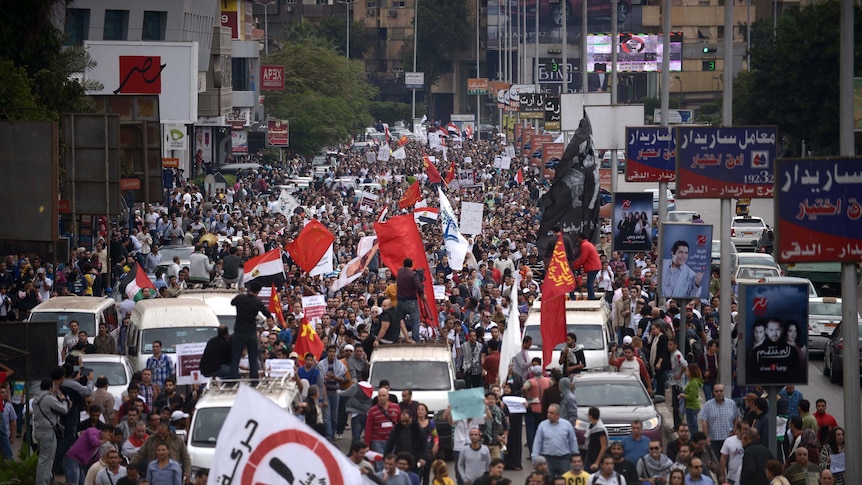 Egyptian demonstrators march through the streets of Cairo to protest against president Mohamed Morsi's power grab