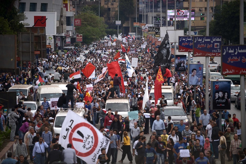 Egyptian demonstrators march through the streets of Cairo to protest against president Mohamed Morsi's power grab