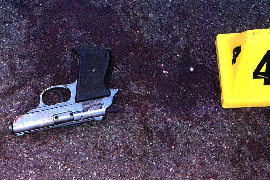 A gun on the ground next to a yellow marker that says 4