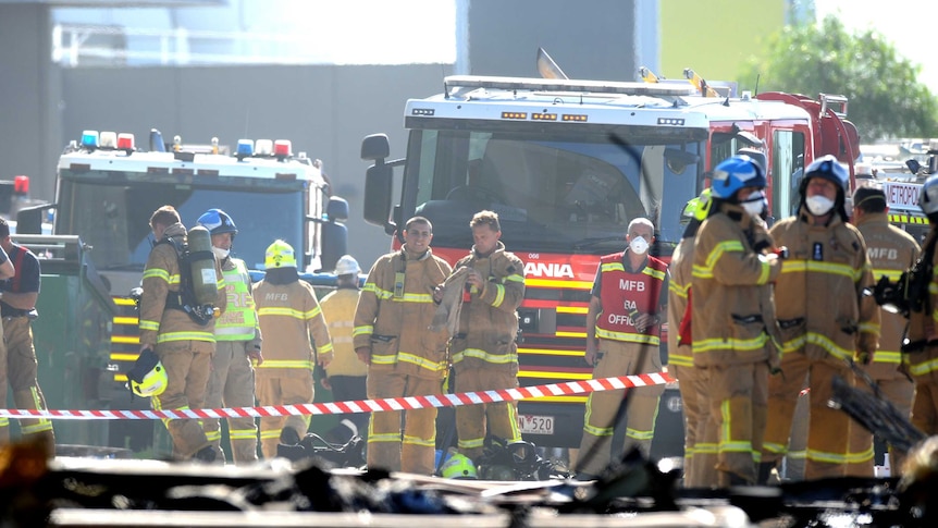 Emergency services personnel are seen at the scene of a plane crash in Essedon.