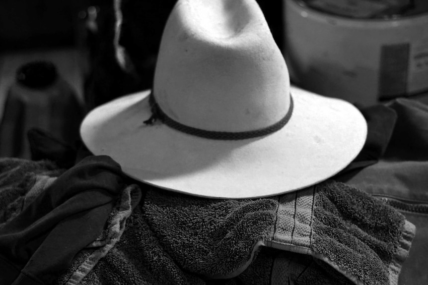 A black and white photo of a hat on a towel.