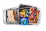A lunch order for wedges, biscuits, two packets of chips, chicken flavoured Shapes, lollies and a fruit box in a cooler bag