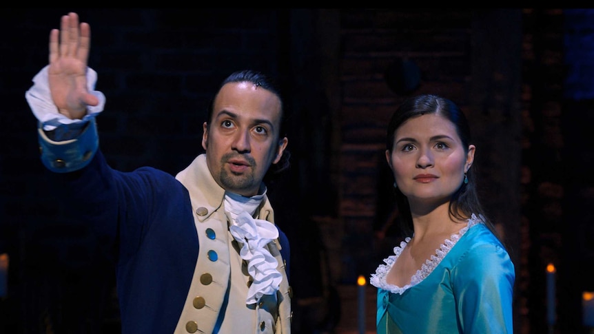 Lin-Manuel Miranda gestures in front of him as Phillipa Soo looks in the same direction