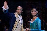 Lin-Manuel Miranda gestures in front of him as Phillipa Soo looks in the same direction