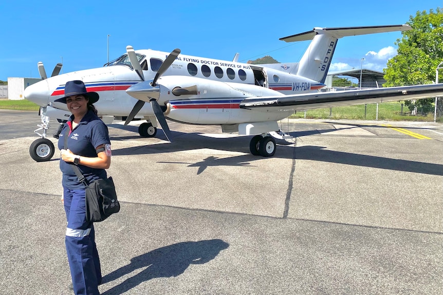 woman in RFDS uniform stands in front of aircraft