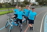 Guinness World Record breaking quadricycle team pose for photo on the track with quadricycle