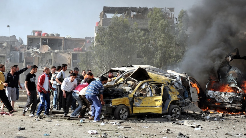 Residents rush to the scene of twin bombings in Damascus