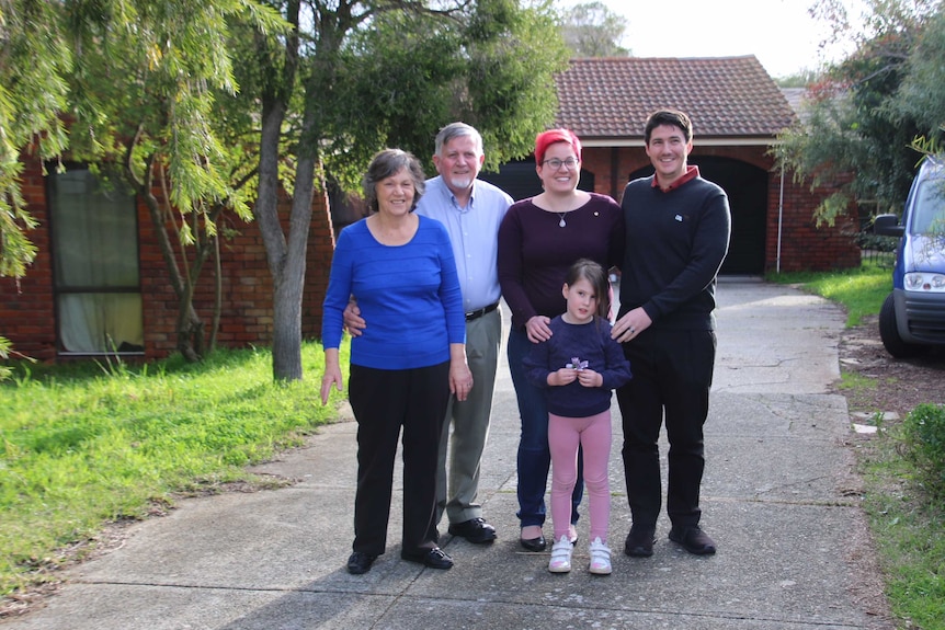 Julie and John Feary, Chrissy and Matt Bruyninckx and their daughter Elena stand outside their Bateman home.