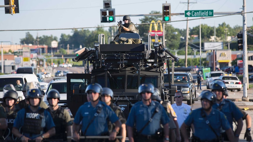 Riot police stand guard in Ferguson, Missouri, on August 13.