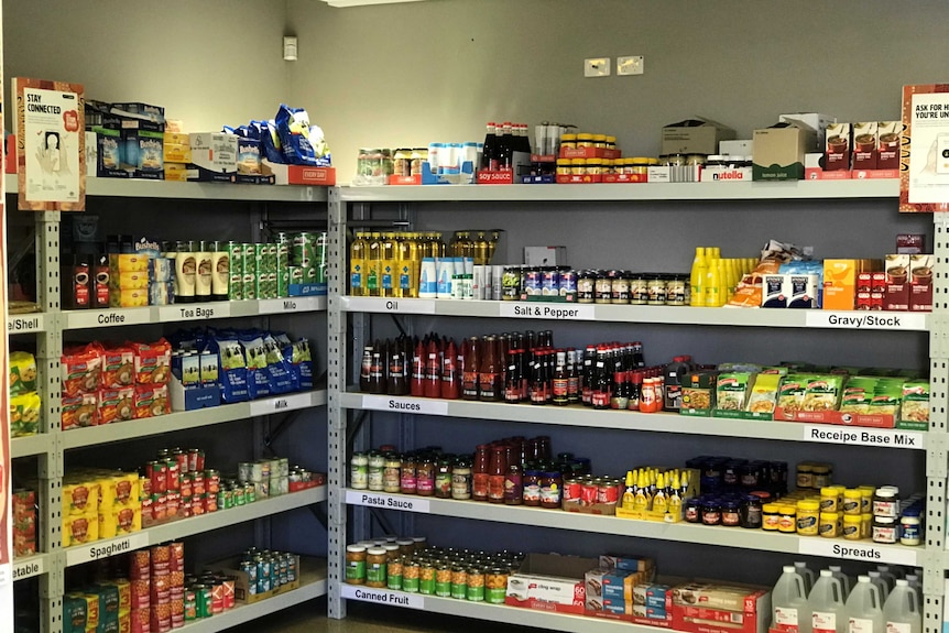 A corner section of shelves, well stocked with supplies.