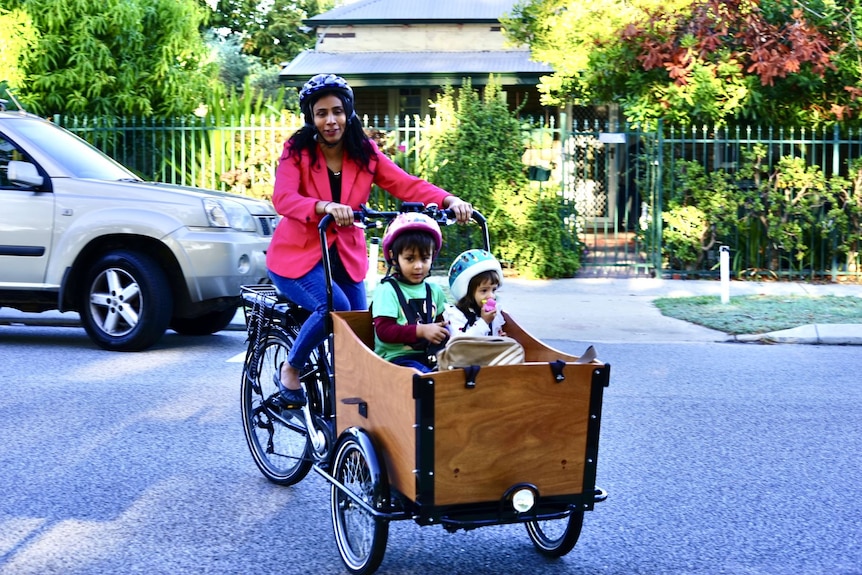 WA Labor candidate Zaneta Mascarenhas with her two children on a bike to vote