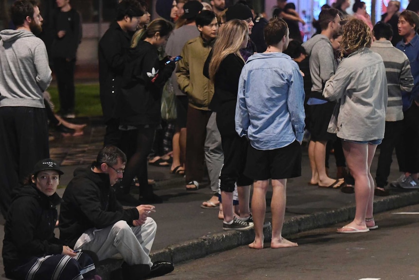 A group of people gather on the street after a strong quake in the Cheviot area of New Zealand.