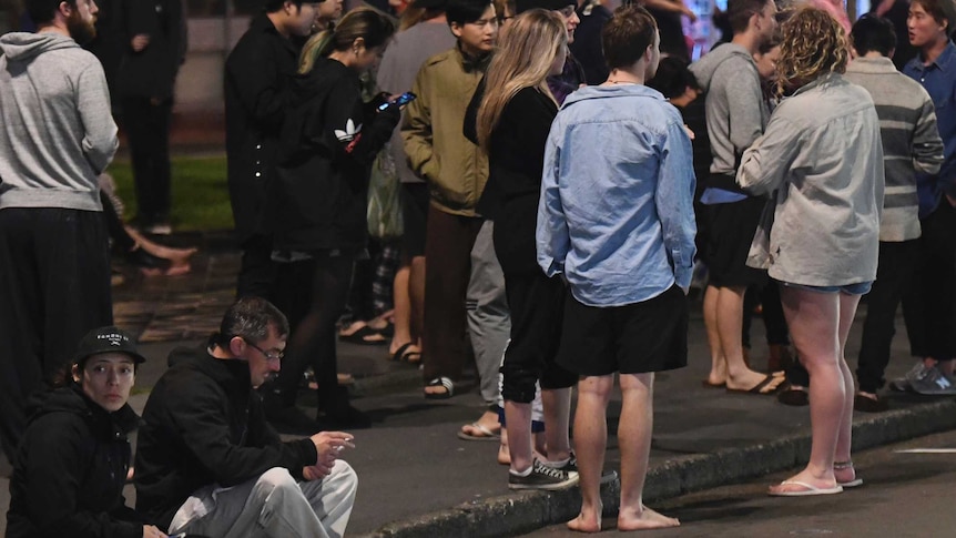 A group of people gather on the street after a strong quake in the Cheviot area of New Zealand.