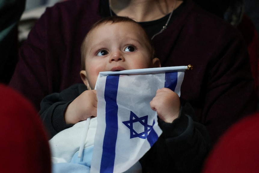 Baby chewing Israeli flag 
