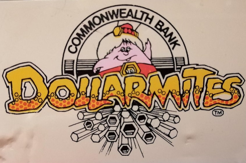 A sticker with a cartoon alien and the Dollarmites logo on the side of a fridge.