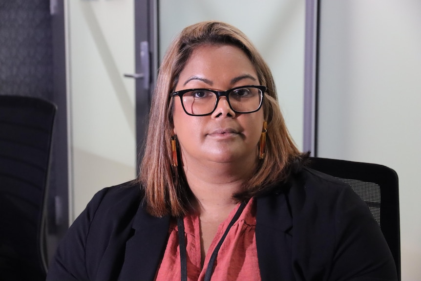 Acting Children's Commissioner Nicole Hucks looks at the camera while in her office.