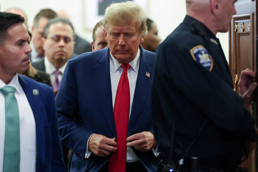 Mr Trump walks through doors next to sheriff 