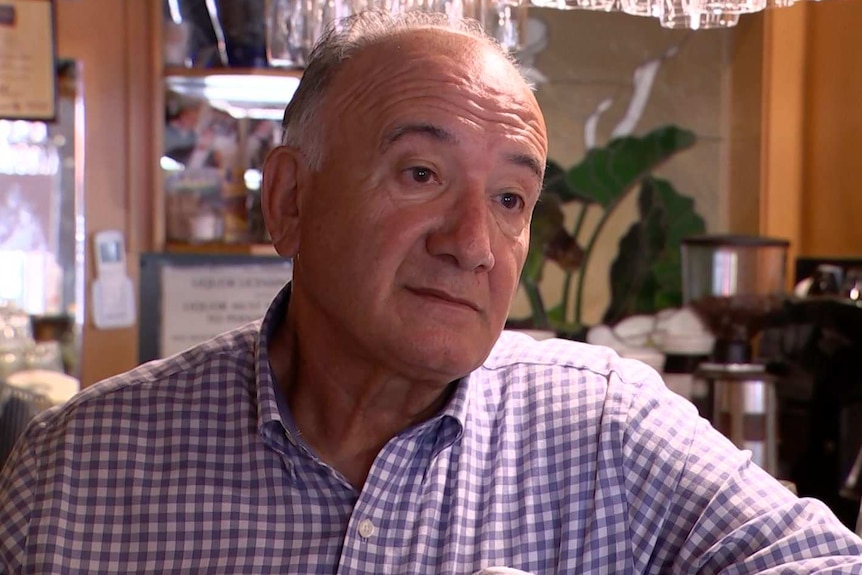 Andy Parisi sits at the bar in his restaurant