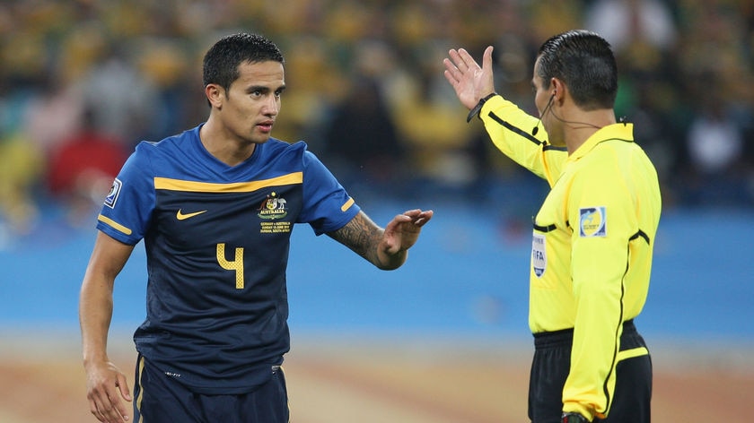 Referee Marco Rodriguez asks Australia's Tim Cahill to leave the pitch after red-carding him during the match against Germany.
