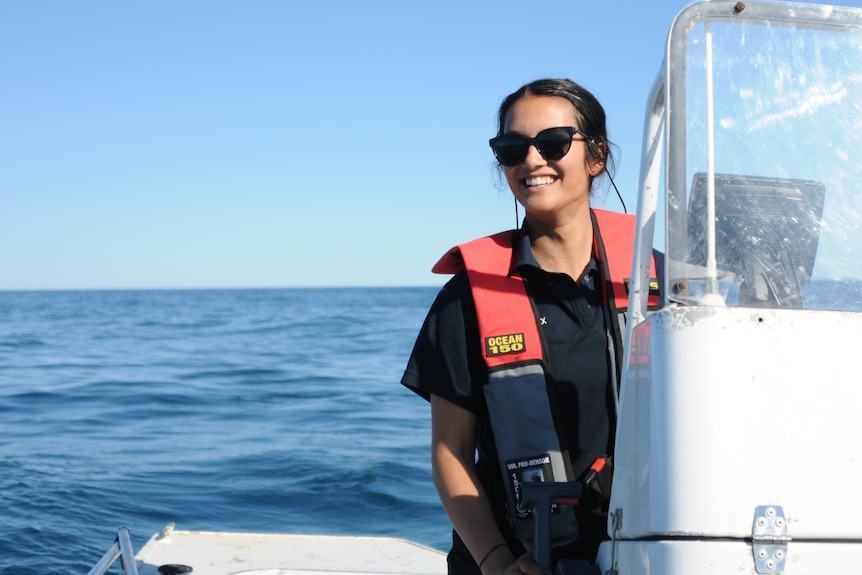 Alexandra D’Cruz on a boat smiling at the camera.