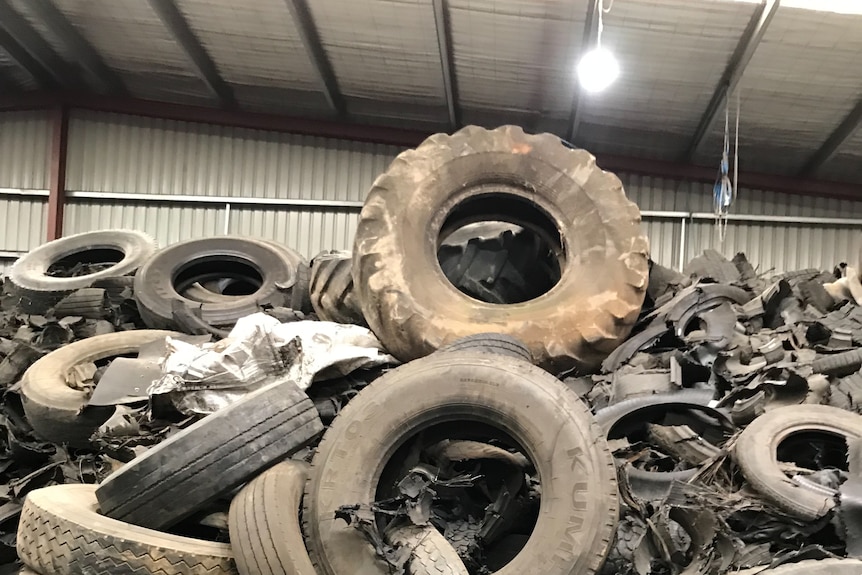 A pile of used tyres in a warehouse 