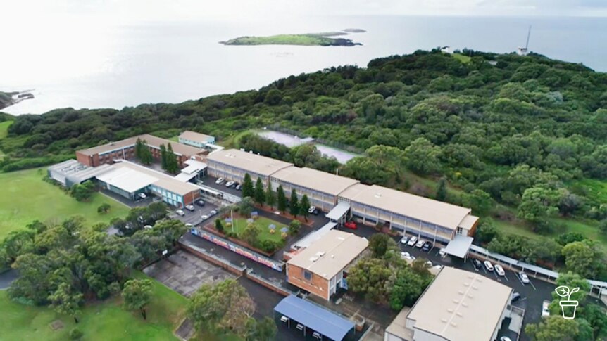 Aerial shot of buildings and vegie gardens in coastal location