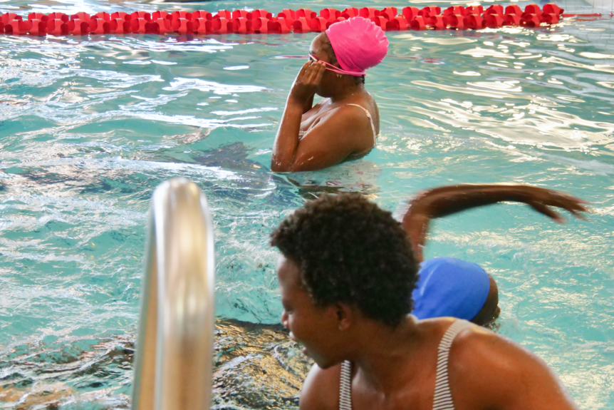 A woman entering the pool for swimming lessons