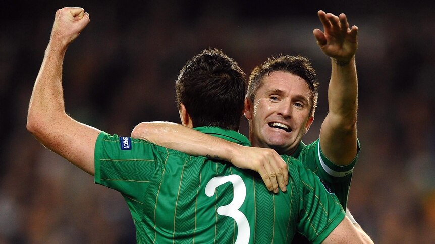 Republic of Ireland players Stephen Ward and Robbie Keane celebrate scoring against Estonia.