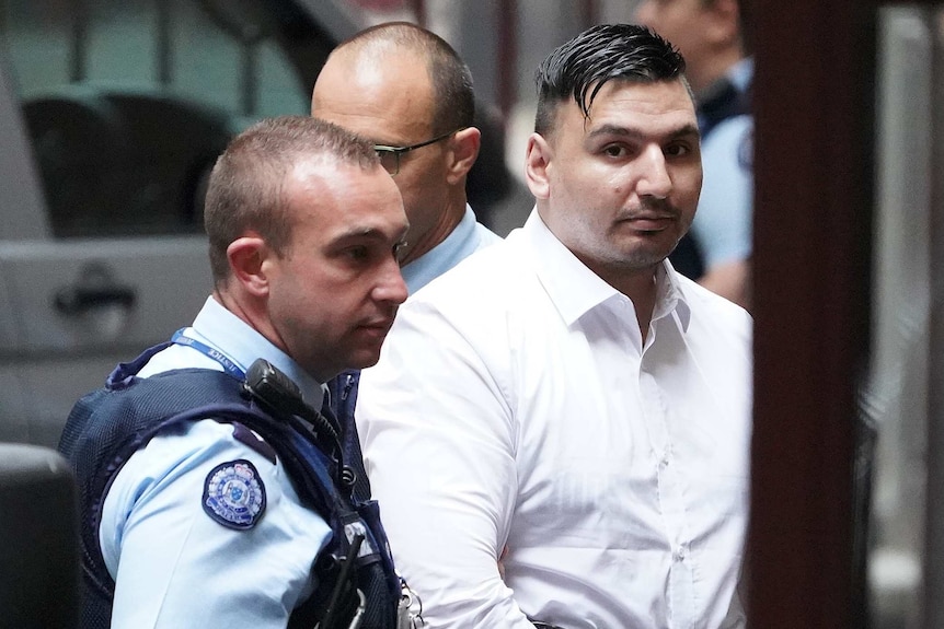 James Gargasoulas is led into court by a police officer.