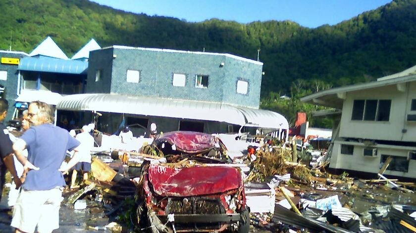 Residents survey the damage after a tsunami flattened large parts of the American Samoan capital