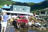 Residents survey the damage after a tsunami flattened large parts of the American Samoan capital