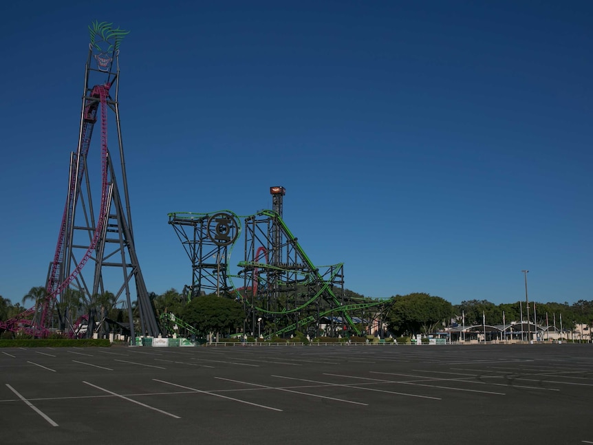 The empty Movieworld car park and roller coasters including one with The Joker face at the top