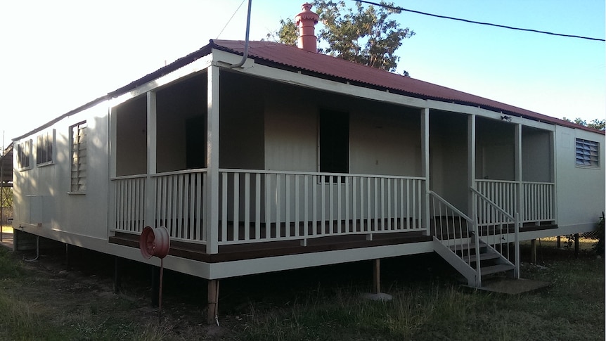 A large white house with a red tin roof