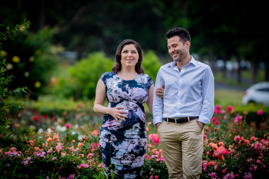 Nas and Tom walk through a rose garden together, both Nas and Tom are smiling and laughing. Ausnew Home Care, NDIS registered provider, My Aged Care