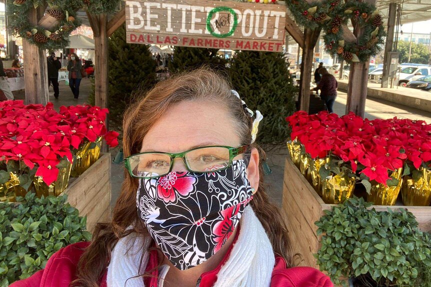 A woman wearing a mask at a farmers market in Dallas, Texas, USA.
