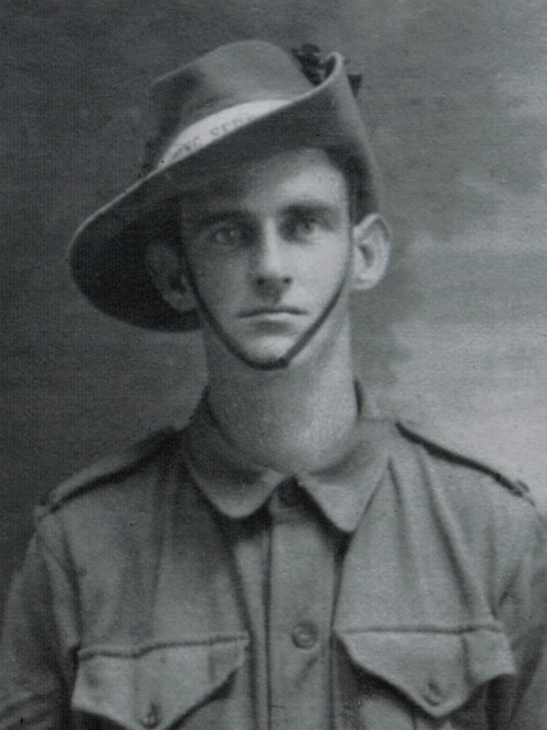 Black and white portrait of WWI soldier in uniform.