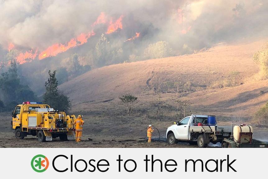 firefighters stand looking at a bushfire, the claim is close to the mark