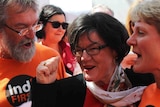 Member for Indi Cathy McGowan surrounded by orange-clad supporters