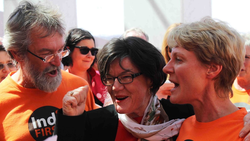 Member for Indi Cathy McGowan surrounded by orange-clad supporters
