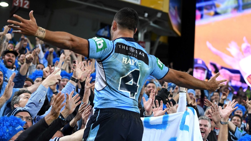 Jarryd Hayne celebrates with Blues supporters after scoring his try in the second half.
