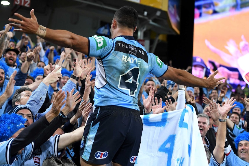 Jarryd Hayne celebrates with Blues supporters after scoring his try in the second half.