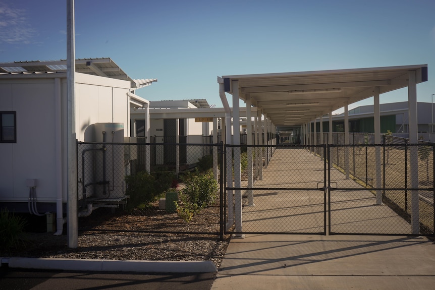 a locked gate leading to a quarantine facility